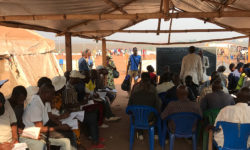 Adult students attending a class in a camp on the outskirts of the city of Dundo, Lunda Norte.