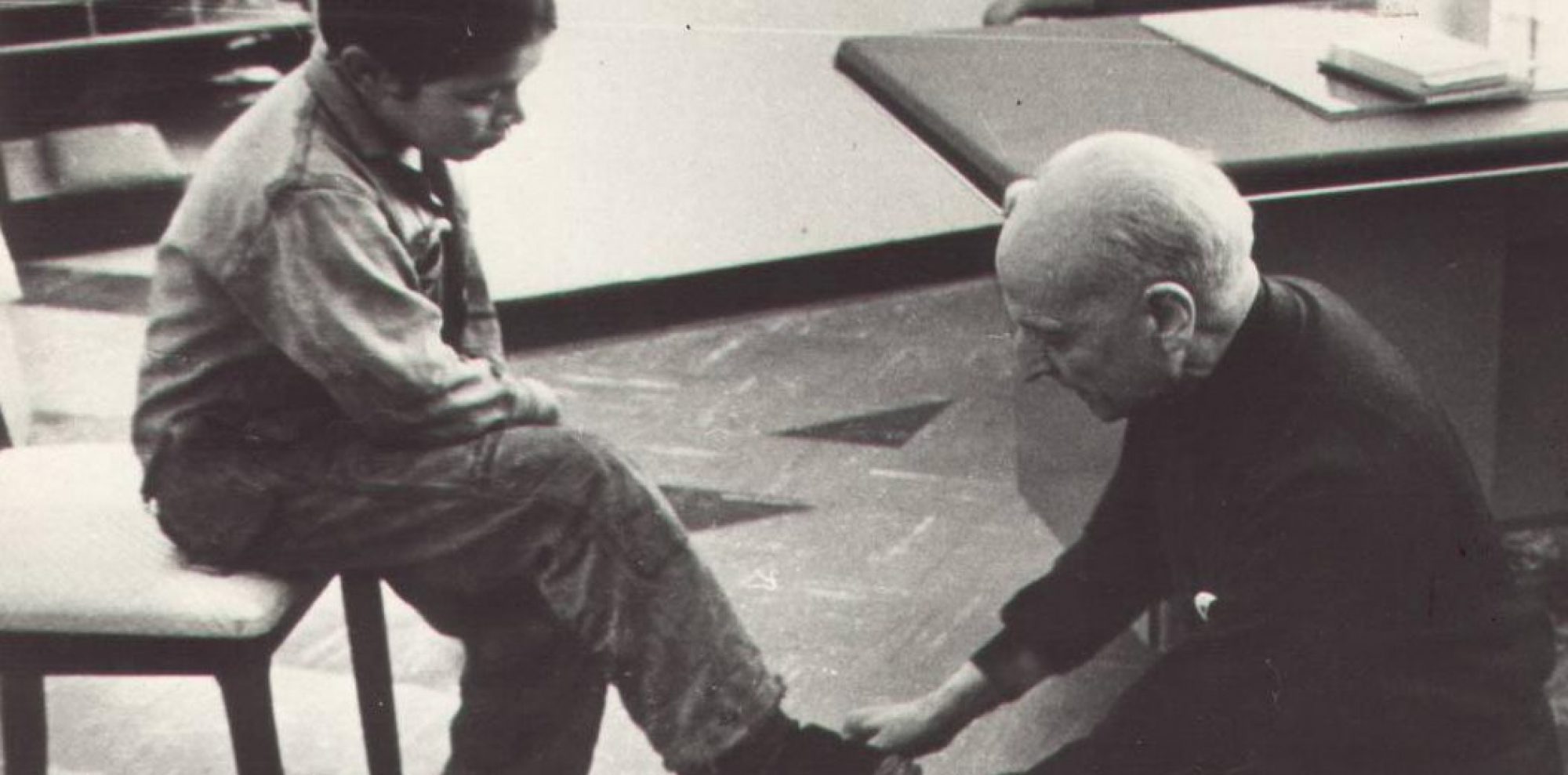 Fr Pedro Arrupe SJ shining shoes for a children in Quito, Ecuador in 1971.