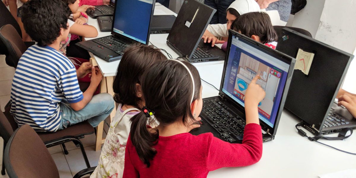 Niñas y niños asisten a clases de informática impartidas por el JRS Grecia.