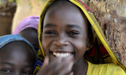Girls smile at the JRS primary school compound in Goz Beida, Chad.
