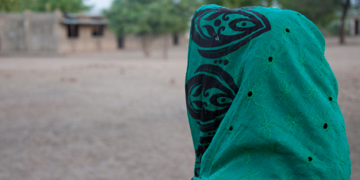 Hiba Abdallah Abou sitting in front of the JRS school in Goz Amir where she now teaches Arabic.