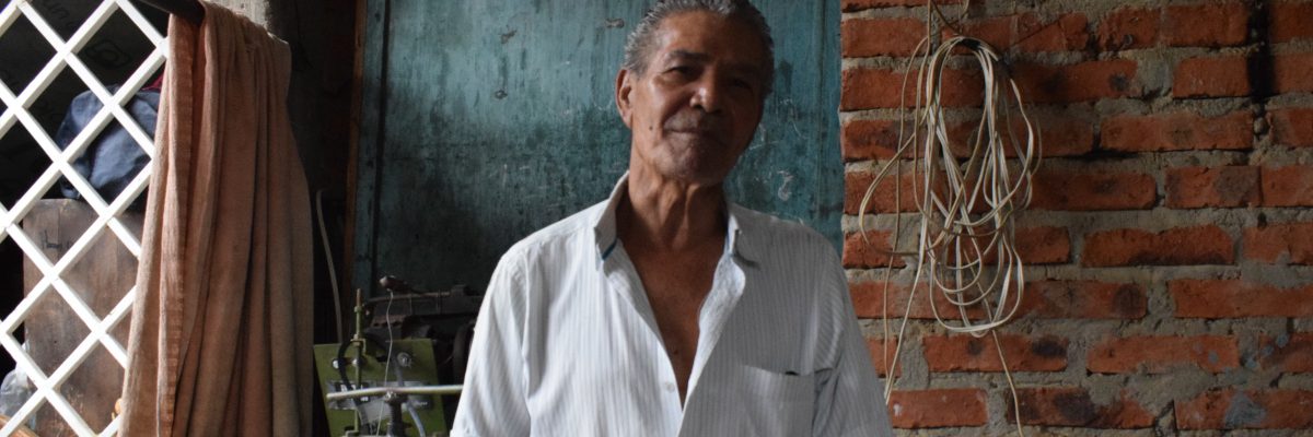 Evelio smiles in his metal workshop. (Jesuit Refugee Service)