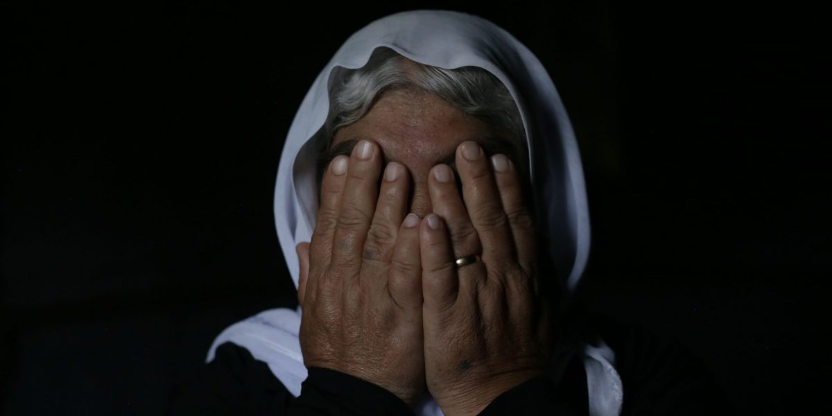 A victim of the Yazidi genocide poses in front of the camera. (Sergi Camara/Jesuit Refugee Service)