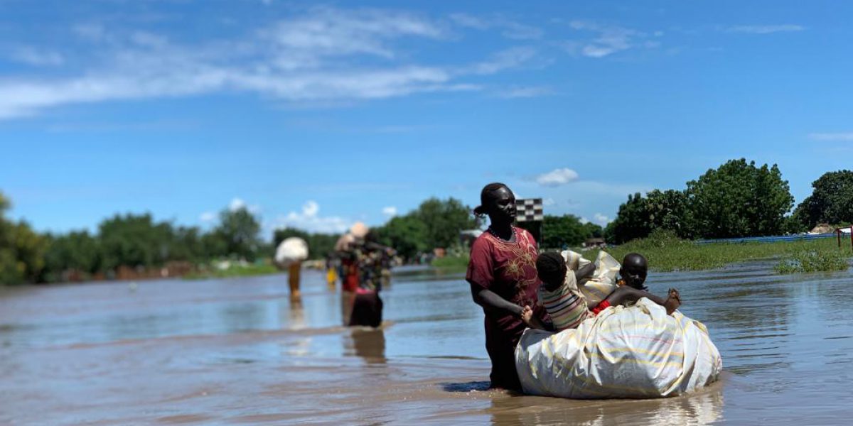 Thousands of people forced to relocate on higher ground, just like this mother and her children.