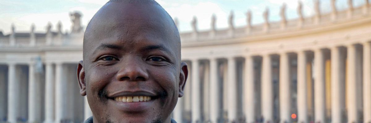 Taban Patrick Consantino SJ poses in front of St Peter's Square in the Vatican. A former JRS refugee student, Taban is now pursuing his vocation to become a Jesuit priest.