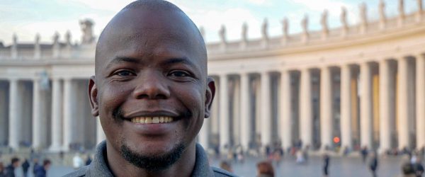 Taban Patrick Consantino SJ poses in front of St Peter's Square in the Vatican. A former JRS refugee student, Taban is now pursuing his vocation to become a Jesuit priest.