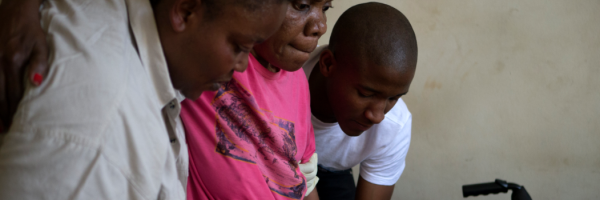 Estelle, an asylum seeker from the DRC living in Johannesburg, walks assisted by Marceline, head of JRS's health department and a JRS volunteer.