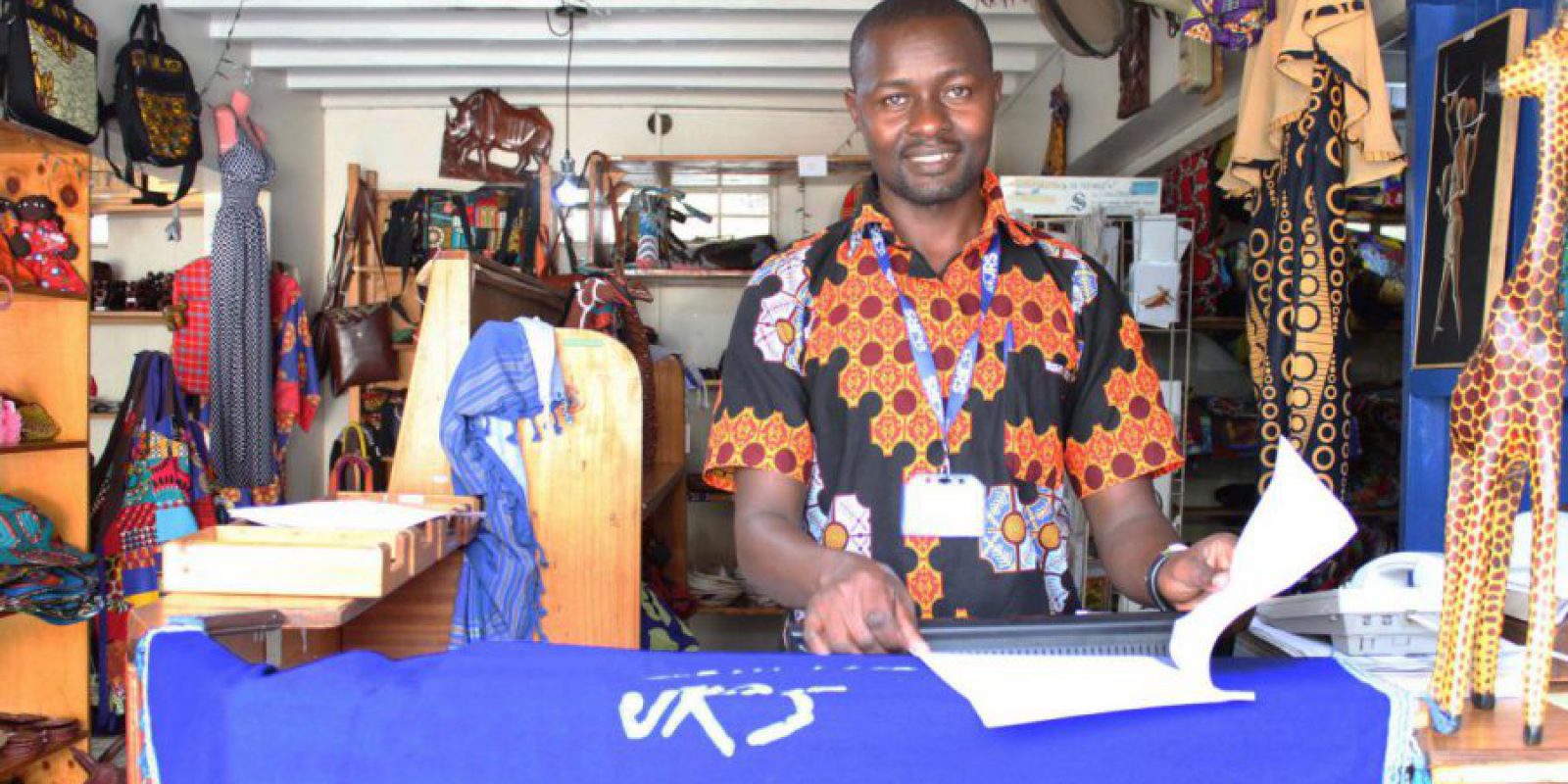 Teddy Salimo runs the JRS Mikono shop, which sells refugee-made handicrafts.