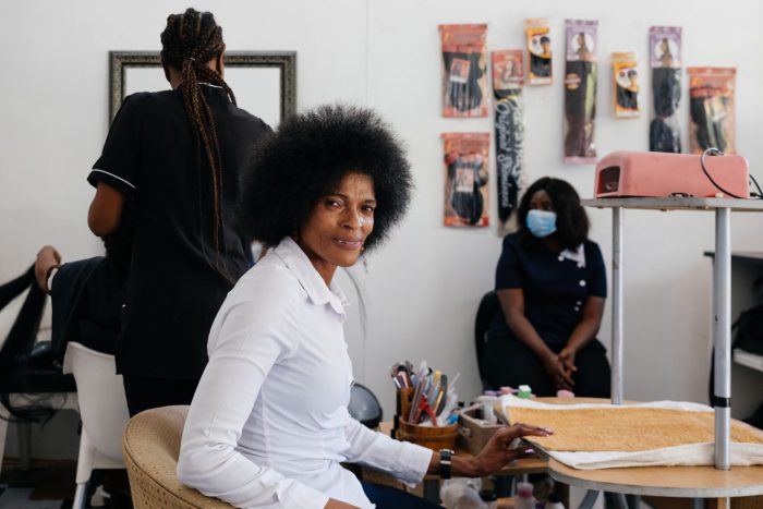 Alina Mofokeng at Thembelihle Hair & Beauty Salon in Pretoria, which she established after successfully completing the beauty course offered by the Jesuit Refugee Service. (James Puttick / New Frame)