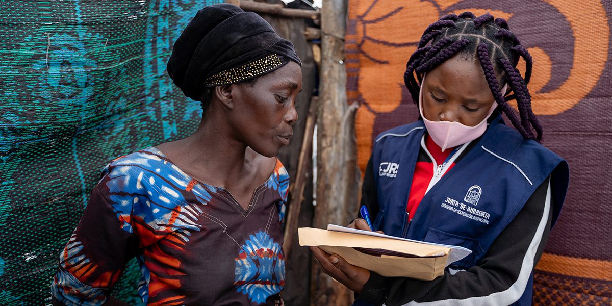 JRS Monitoring and Evaluation Officer meets those affected by the eruption in Mujoga to assess their needs.