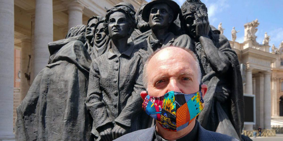 Thomas H. Smolich SJ, JRS International Director, in front of “Angels Unaware”, a sculpture in St. Peter’s Square, Vatican City by Canadian artist Timothy P. Schmalz dedicated to the world’s migrants and refugees.