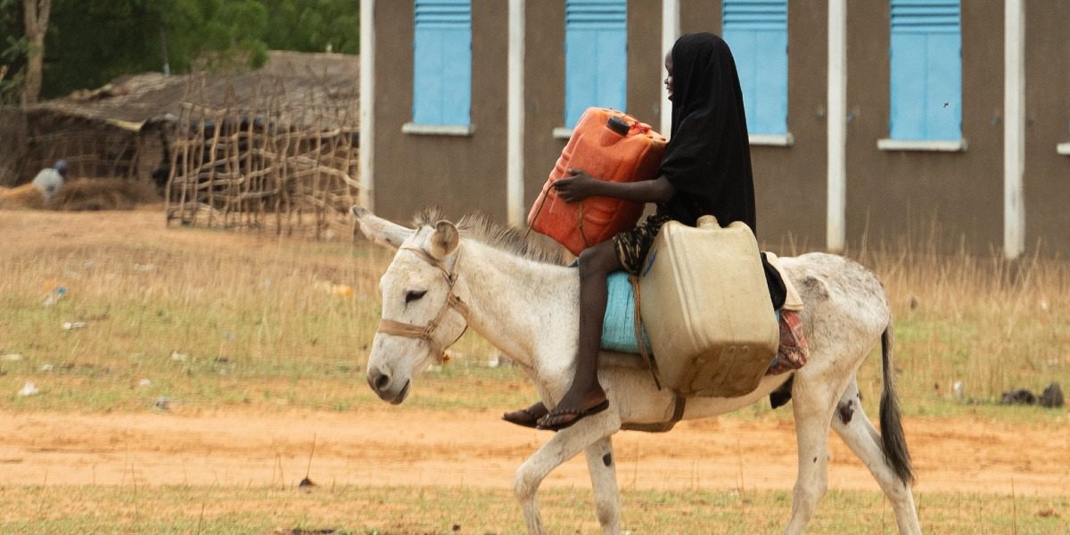 A girl carrying water in Djabal refugee camp, Chad. JRS Chad responded to the crisis in Sudan by intervening to ensure access to education for Sudanese refugees.