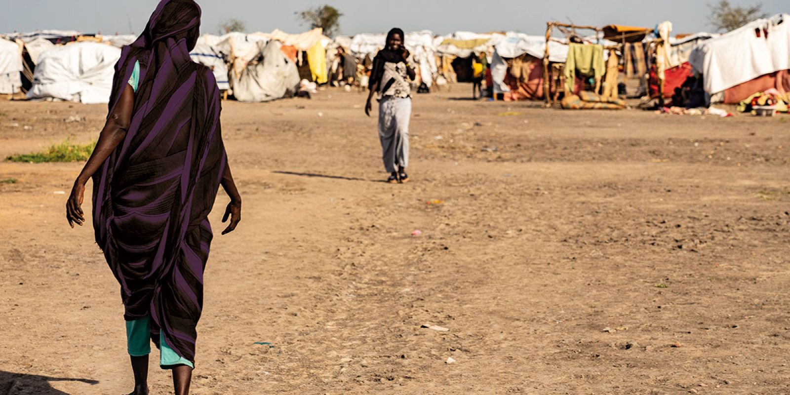 A woman walking in a camp in Renk, South Sudan, where people fleeing the conflict in Sudan are seeking refuge.