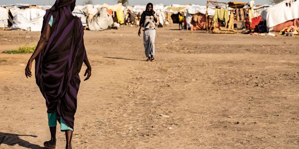 A woman walking in a camp in Renk, South Sudan, where people fleeing the conflict in Sudan are seeking refuge.