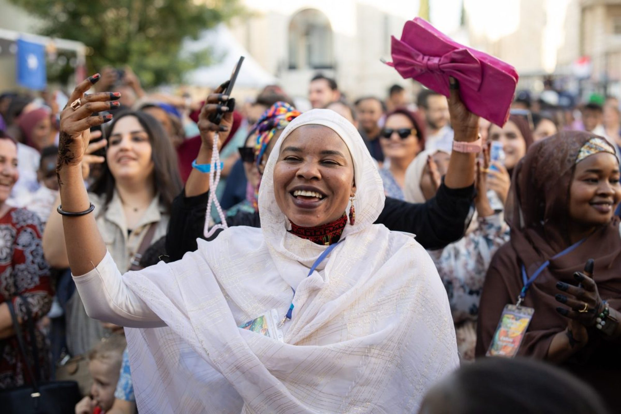 People from different backgrounds smiling as they gather together at the Festival of Encounter organised by JRS Jordan