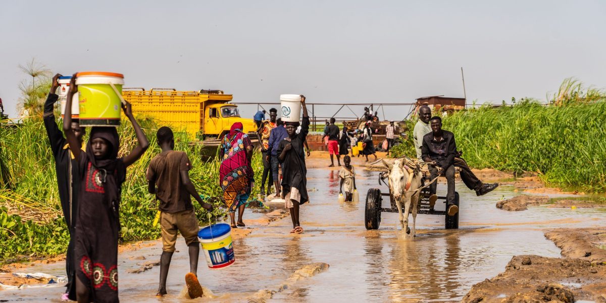 Displaced communities saving their belongings after floods in Renk, South Sudan.