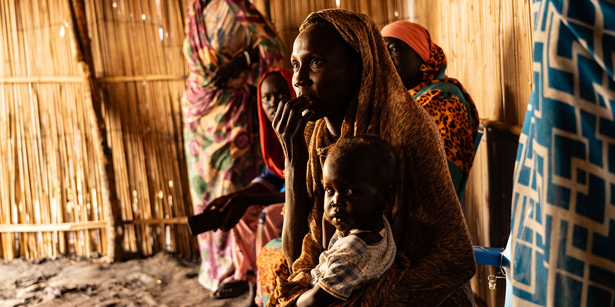 A mum and her son receive pysiotherapy and basic needs services in a refugee camp